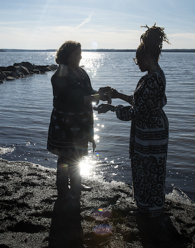 two women standing on the bank of the Potomac River